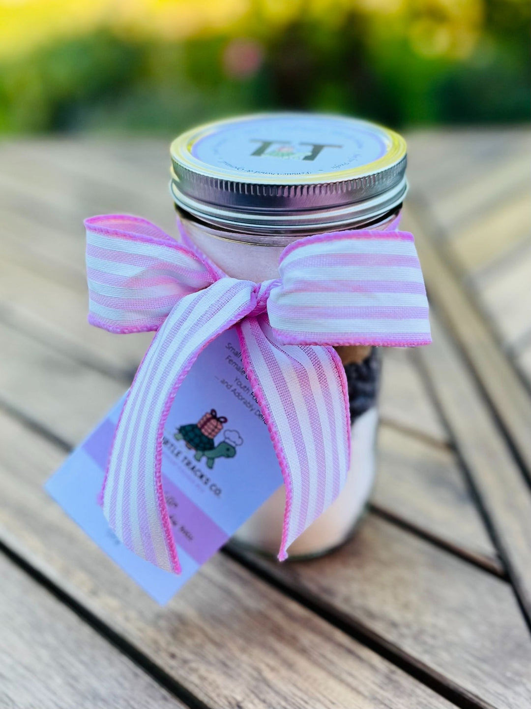A jar of Ghirardelli Chocolate Chip Cookie Mix, by Turtle Tracks, with a pretty pink ribbon. 